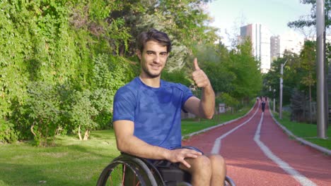 Young-man-with-physical-disability-looking-at-camera-and-smiling.